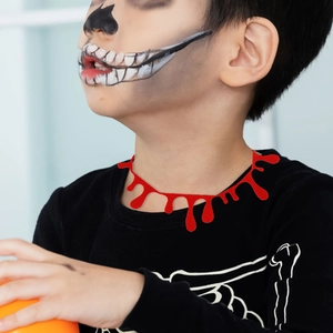 Close-up of a dripping blood effect Halloween choker on a model with skull makeup