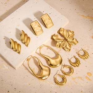 Collection of geometric 18k gold plated stainless steel hollow earrings on stone base