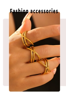 Close-up of three gold intertwined minimalist rings on a finger with light shadows