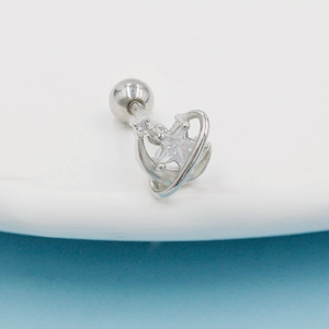 Macro shot of silver star stud earring with a bright zircon and ball back closure
