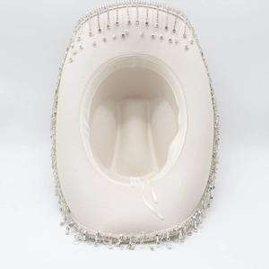 Detail of white western cowboy hat featuring sparkling silver rhinestone fringe on brim