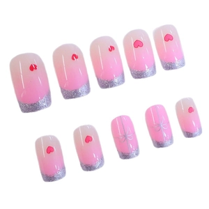 Pink gradient French press-on nails with silver glitter, red hearts and bow accents