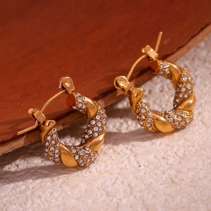 Detailed macro view of 18K gold plated twist hoop earrings with pavé set white zircons