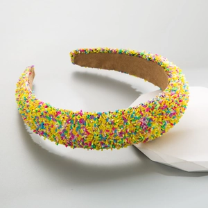 Detail of wide headband with colorful sprinkle beads and soft light brown fabric base