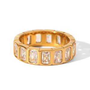 Detailed macro shot of a gold eternity band featuring rectangular zircon stones
