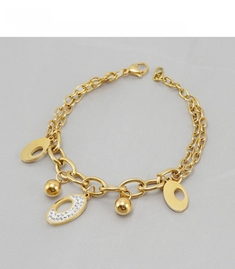 Close-up of 18K gold plated double layer bracelet with pavé crystal oval charms