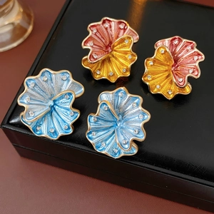 Detailed view of vintage floral earrings with colorful enamel and rhinestone accents