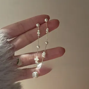 Detailed close-up of French vintage long tassel earrings with real freshwater pearls