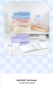 Detailed close-up of macaron color pencil cases stacked on a minimalist office desk
