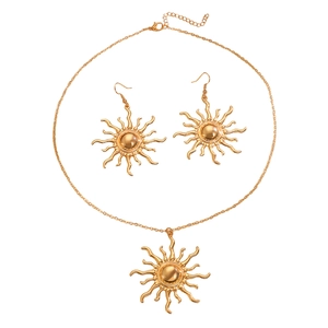 Golden sunburst jewelry set with necklace and stud earrings in polished metal