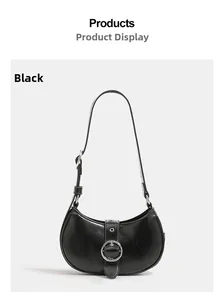 Detailed view of black moon-shaped shoulder bag with large silver buckle accent