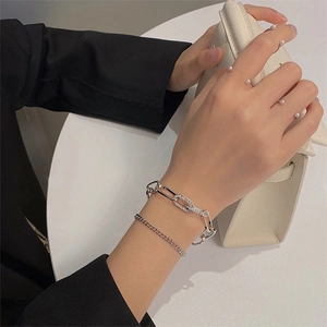 Silver multi-layer geometric chain bracelet with sparkling crystals on female wrist