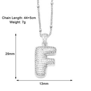 Macro shot of silver letter F pendant with zircon pavé and detailed size specifications