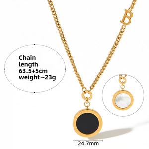 Detail of gold double-sided round pendant with black onyx, white pearl and Roman numerals