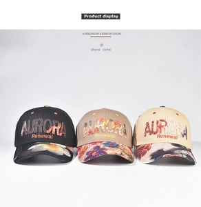 Close-up of AURORA Renewal embroidered baseball caps with floral patterns in three colors