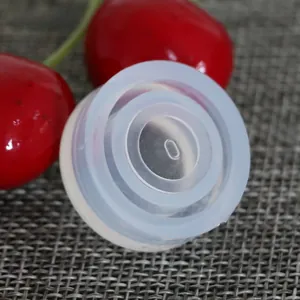 Macro detail of a translucent silicone gasket with concentric tiered design and center slot