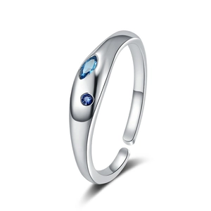Adjustable silver minimalist ring with marquise and round blue crystals on white background
