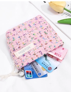 Detailed shot of pink tweed coin purse with pearl chain and internal card slots