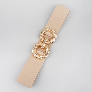 Detailed macro view of beige elastic fabric texture and golden interlocking metal buckle