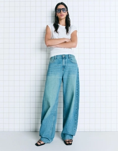 Detail view of retro high-waisted wide-leg jeans styled with a basic white cotton t-shirt