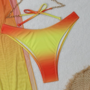Detail of gradient orange bikini bottoms with golden chain straps and mesh texture