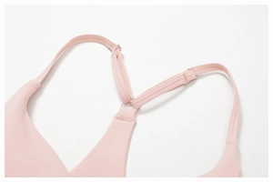 Detail of pink yoga bra adjustable straps with metal rings and Y-back design