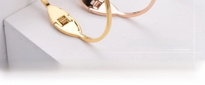 Macro shot of minimalist dolphin tail bangles showing precision spring clasp structure