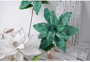 Close-up of artificial green and white poinsettia flowers with glitter and bead details