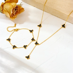 Titanium steel butterfly necklace and bracelet set with black shell inlays in gold