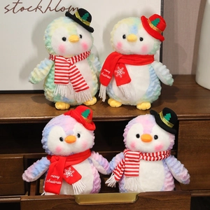 Colorful tie-dye Christmas penguin plush toys with festive hats and red scarves