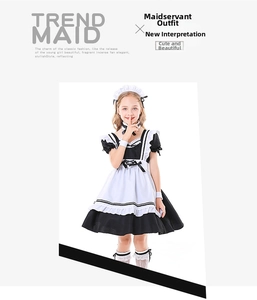 Detail shot of girls classic black and white maid costume with ruffles and lace bow details