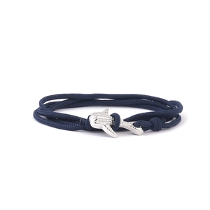 Navy blue braided rope bracelet featuring a textured silver shark-shaped metal clasp