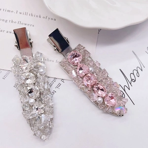 Exquisite pink and silver crystal hair clip set with pearl accents on a white background
