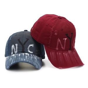Distressed NYC baseball caps in blue and wine red with white paint graffiti brim detail