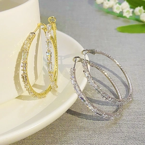 Luxurious gold and silver hoop earrings with shimmering rectangular cubic zirconia stones