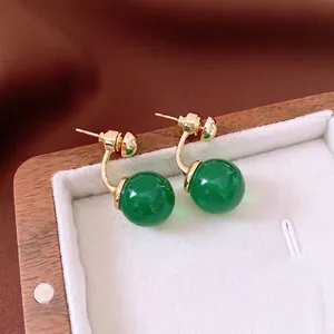 Vintage style green marble sphere earrings with gold C-shape hooks in a jewelry box