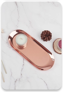 Macro shot of rose gold oval stainless steel tray with polished mirror finish