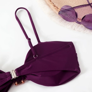 Detail of purple bikini top featuring adjustable straps and silver metal back buckle clasp