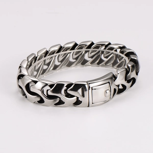 Detail of chunky stainless steel chain bracelet with rectangular clasp closure for men