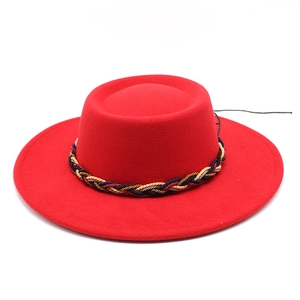 Detail of red wool felt wide-brim fedora with red, black and gold woven decorative band
