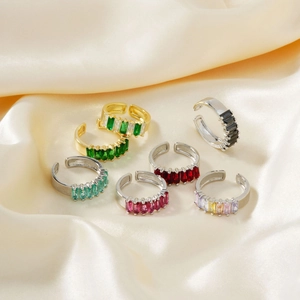 Set of seven adjustable open rings with colorful rectangular crystals on silk fabric