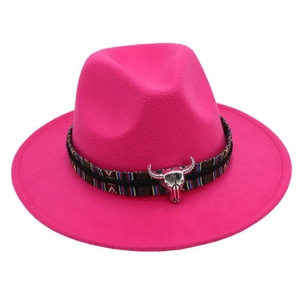 Detail of rose red wool felt fedora with ethnic band and silver bull skull charm