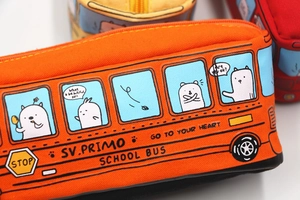 Detailed shot of orange canvas school bus pencil case with cartoon bear and zip closure