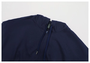 Detail of navy blue hoodie featuring flat drawstrings with silver tips and size S label