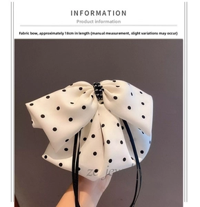 Detail of polka dot bow hair clip with black beads and 18cm long ribbons