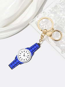 Creative watch-shaped keychain with gold lobster clasp on elegant white silk background