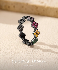 Macro detail of S925 silver four-leaf clover ring with colorful stones and 925 hallmark