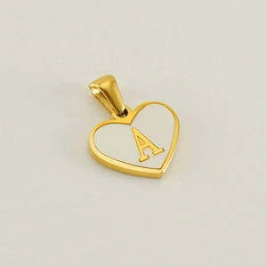 Detail of a heart pendant in gold and white with an engraved letter A on a white background
