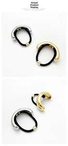 Detail of U-shaped gold and silver metal hair rings with durable black elastic bands