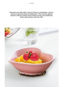 Pink heart-shaped ceramic bowl with vertical relief texture filled with fresh fruits